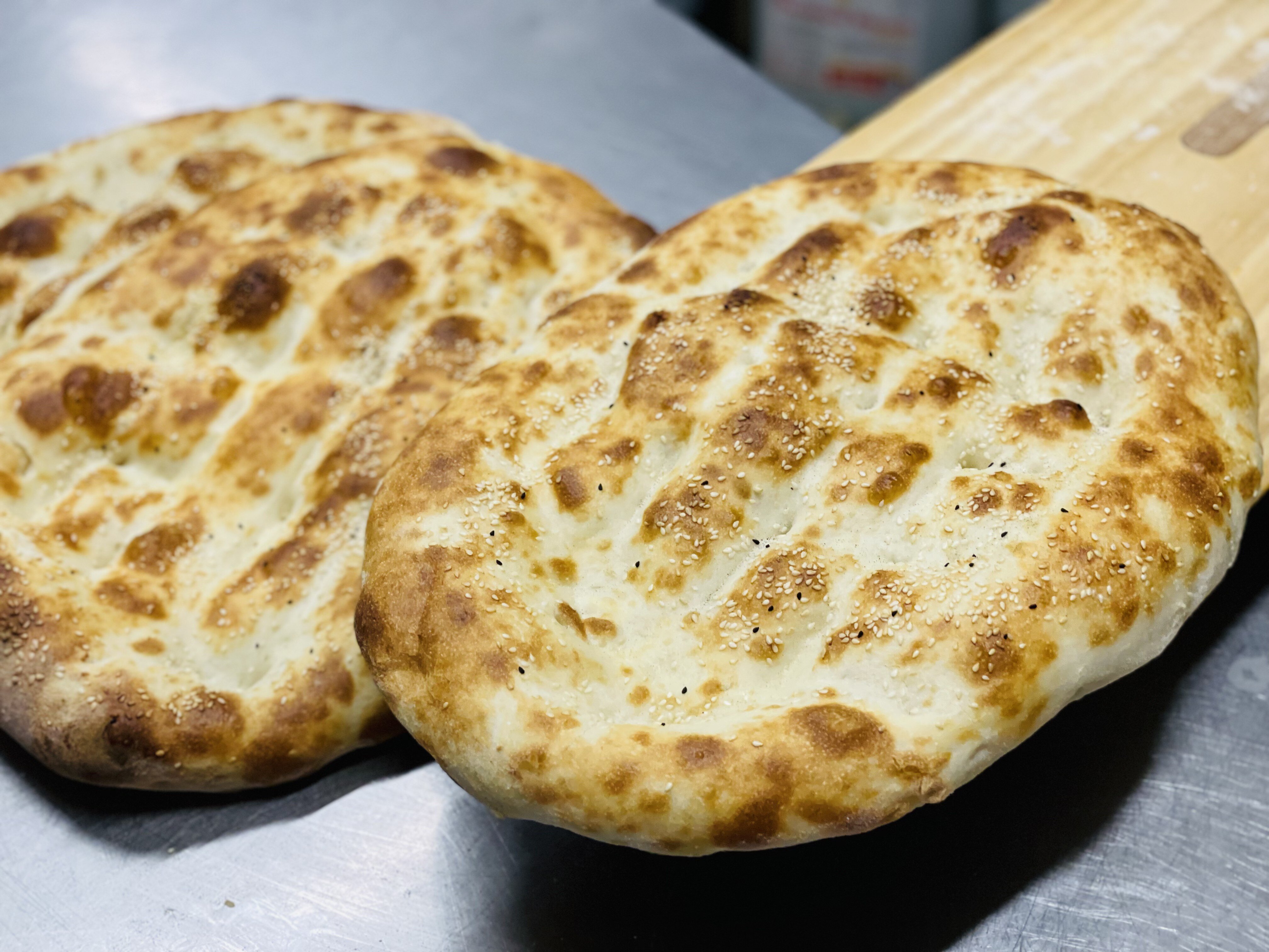 Freshly baked Anatolian Grill Turkish bread topped with sesame seeds